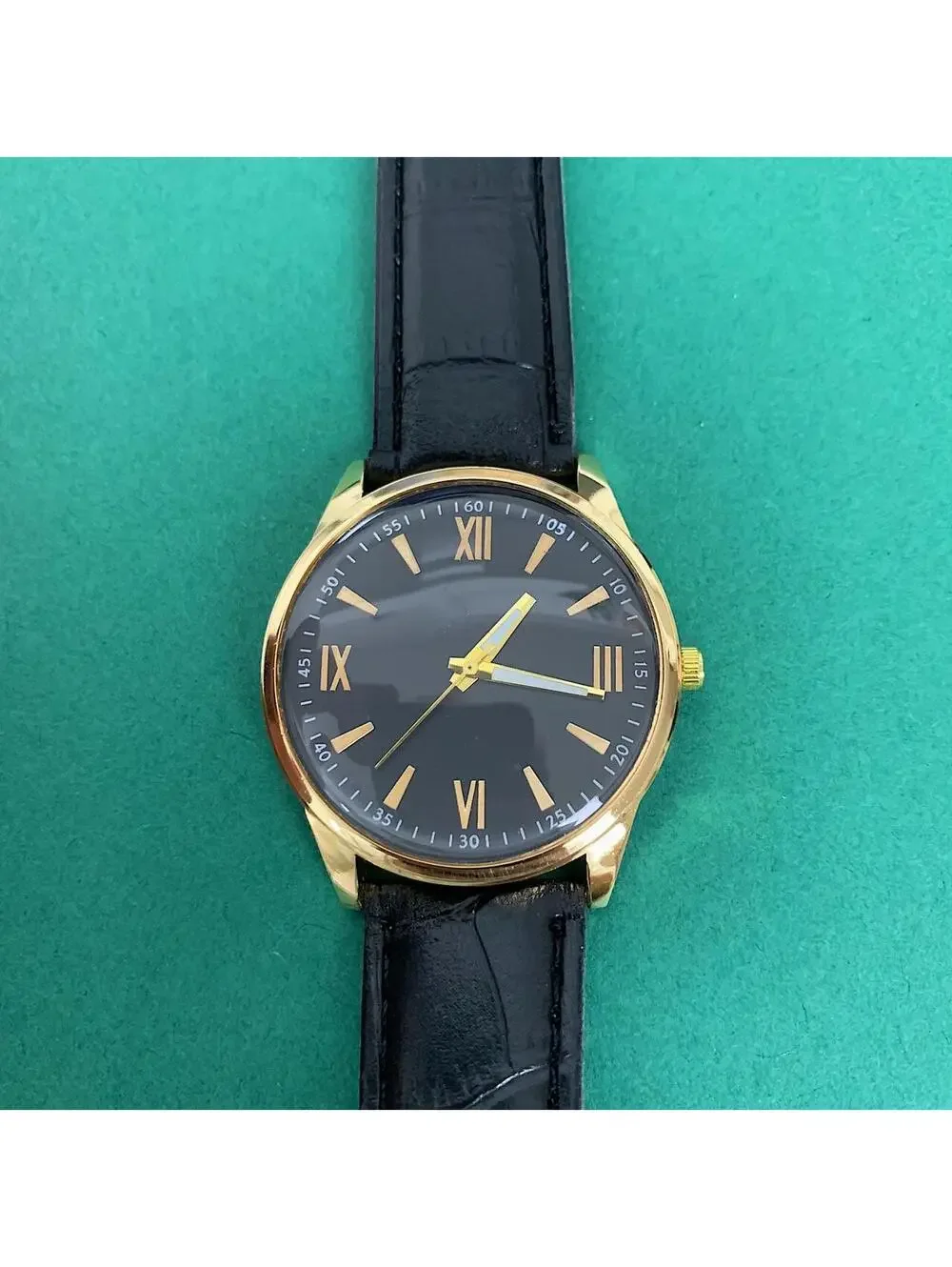 Minimalistic Black essential vintage style gold and leather style band watch. 9